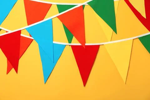 Buntings with colorful triangular flags on orange background Stock Photos
