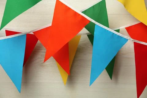 Buntings with colorful triangular flags on white wooden background 스톡 사진