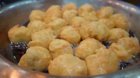 Buñuelos frying in a pot Stock Footage 295400301