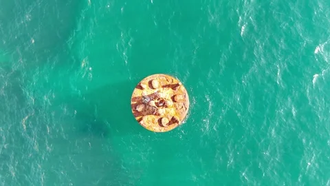 Buoys circular shape and rusted texture, surrounded by clear ocean waves Stock Footage 336312942