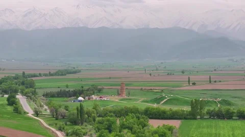 Burana Tower, drone panoramic with snowy mountains backdrop. Kyrgyzstan Vidéo 336850674