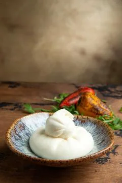 Burata cheese in a plate. Stock Photos