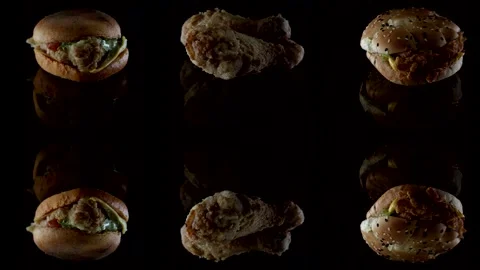 Burger and chicken drumsticks in breaded close-up on a black background lie on Stock Footage 146177240