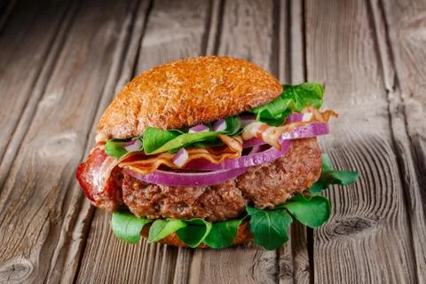 Burger with bacon close up. Stock Photos