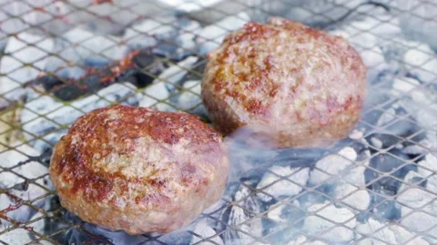 Burger BBQ meat cutlets fried on the grill, raw beef on frying coals copy space Stock Footage 155975165