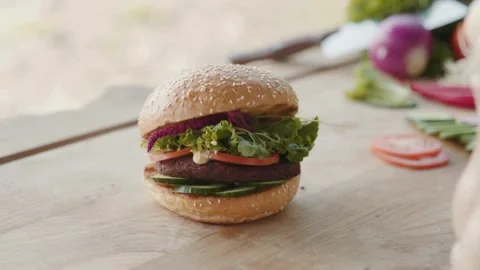 Burger with beef and vegetables rotates. cutlet, Hamburger with fries rotated on Stock-Footage 336579452