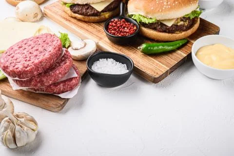 Burger with beef for grill on white background with copy space Stock Photos