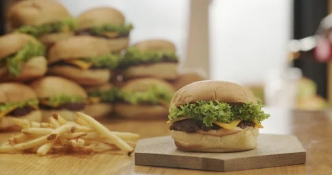 Burger with beef patty, sauce, lettuce and cheddar cheese Stock Footage 117586452