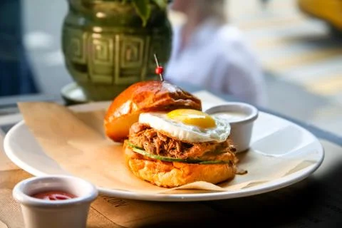 Burger with beef stew and egg lying on a plate Stock Photos
