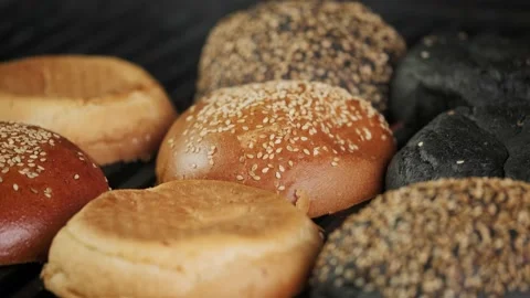 Burger bun is fried on a grill grid. Stock Footage 153544345