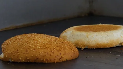 Burger buns toasted on the grill. Preparing of the burger Stock Footage 86176973