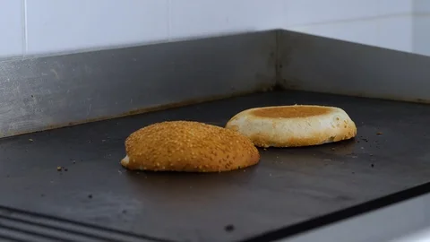 Burger buns toasted on the grill. Preparing of the burger Stock Footage 86429244