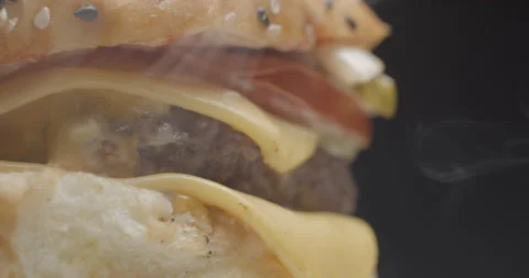 Burger close-up rotating in studio. Tasty fast food. Video stock 144799043