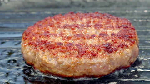 Burger cutlet being fried in a hot cast iron pan Slow motion video 50fsp. Stock Footage 324785799