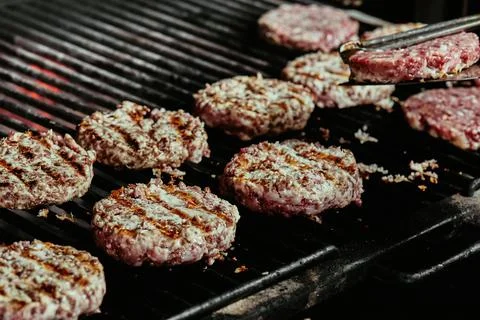 Burger cutlets on a grill - cutlets made from organic beef. raw cutlets. close Stock Photos