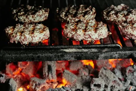 Burger cutlets on a grill - cutlets made from organic beef. raw cutlets. close Stock Photos