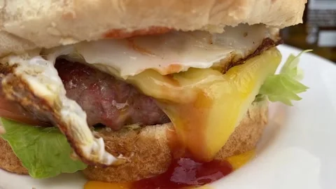 Burger with dripping egg. Concept fast food. Stock Footage 130351532