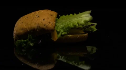 The Burger falls in slow action on the table Stock Footage 80427216