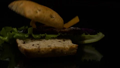 The Burger falls in slow action on the table Stock Footage 80427471