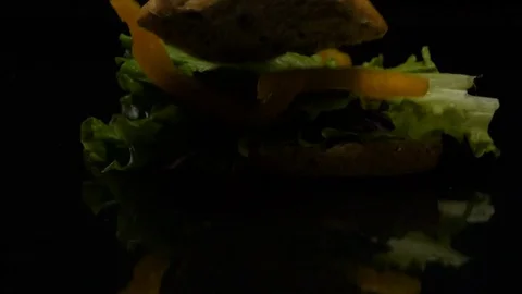 The Burger falls in slow action on the table Stock-Footage 80428155