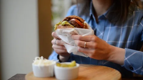 Burger in female hands close up leaking Stock Footage 101116747