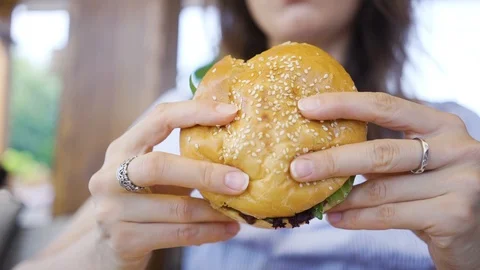 Burger in female hands close up leaking Stock Footage 105187175
