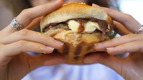 Burger in female hands close up leaking Stock Footage 105188069