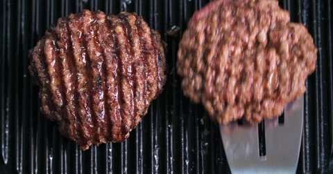 Burger flipped on grill Video stock 60779136