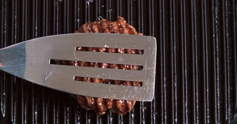 Burger flipped on grill 스톡 동영상 60786816