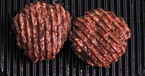 Burger flipped on grill Video stock 60787065