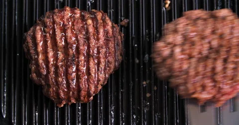 Burger flipped on grill Video stock 60787376