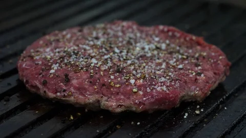 Burger flipped on the stone grill. Preparing of the burger Stock Footage 86177090