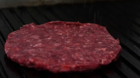 Burger flipped on the stone grill. Preparing of the burger Stock Footage 86177112