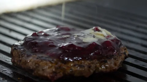 Burger flipped on the stone grill. Preparing of the burger Stock Footage 86177327