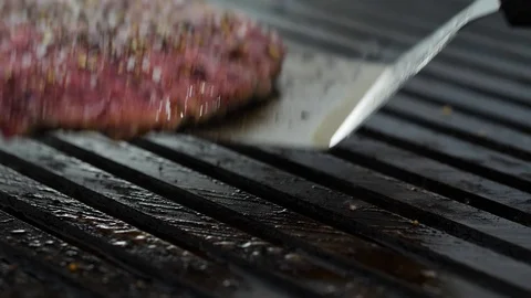 Burger flipped on the stone grill. Preparing of the burger Stock Footage 86177403
