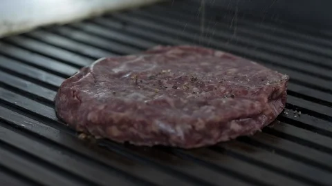Burger flipped on the stone grill. Preparing of the burger Video stock 86178459