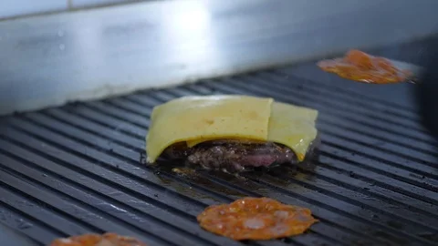 Burger flipped on the stone grill. Preparing of the burger Stock Footage 86178717