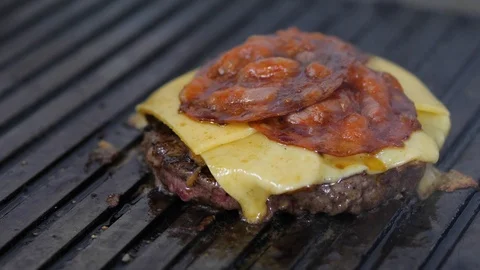 Burger flipped on the stone grill. Preparing of the burger Stock Footage 86178728