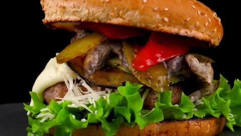 Burger with grilled vegetables and pickled cucumbers, close-up view Stock Footage 84652525