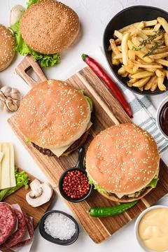 Burger with ingredients on white background, flat lay Stock Photos