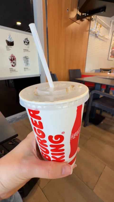 Burger King drink cup with straw inside restaurant setting, emphasizing fas.. Stock Footage 336274235