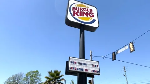 Burger King now hiring message on a street sign Washington Road Stock Footage 174908013