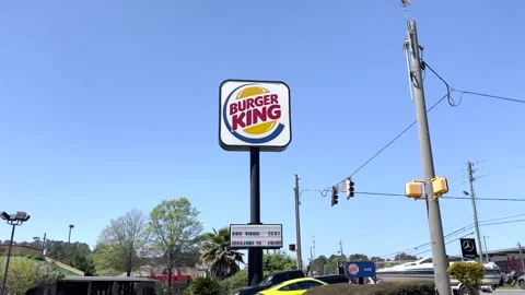 Burger King now hiring message on a street sign and traffic on Washington Roa Stock Footage 174908753