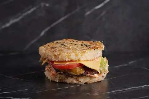 Burger with meat and cheese on the table, american cuisine, close-up, tomato Stock Photos