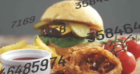 Burger, onion ring, numeric overlay moving, camera pulling back, revealing main Stock Footage 331820629