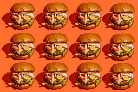 Burger pattern with hard shadows on an orange background. Stock Photos
