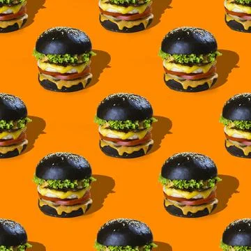 Burger pattern on orange background Stock Photos