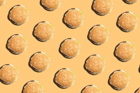 Burger pattern on a yellow background. Top view. Stock Photos