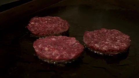 A burger patty being fried. Slow motion. Stock Footage 303745708