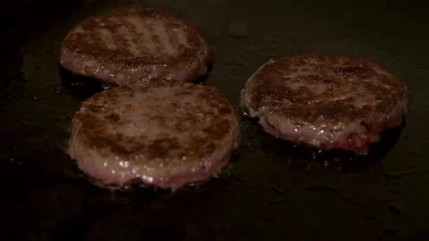 A burger patty being fried. Slow motion. Stock Footage 303745765
